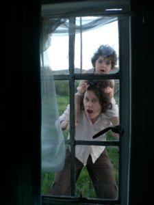 Looking in together: through the window.