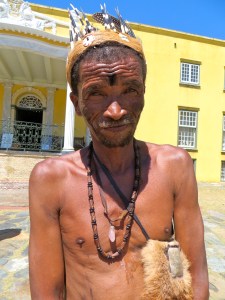 A Khoi San Medicine man in traditional dress posed in the courtyard of the colonial Cape Town Castle.